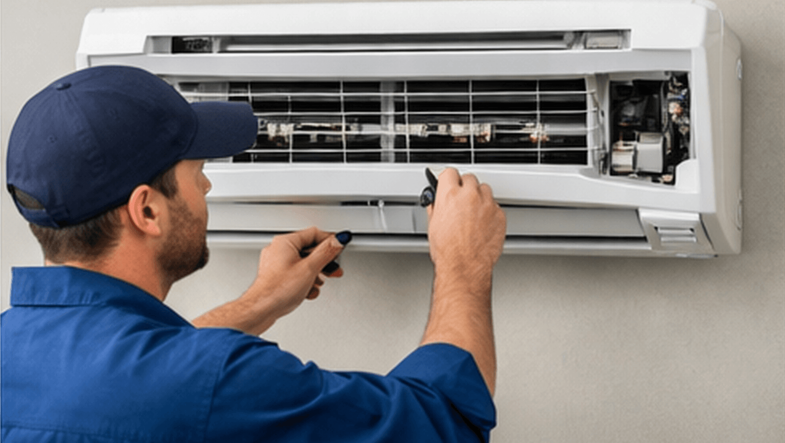Technician servicing a residential air conditioner